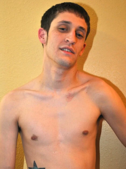 Adult model in a shirtless upper-body portrait